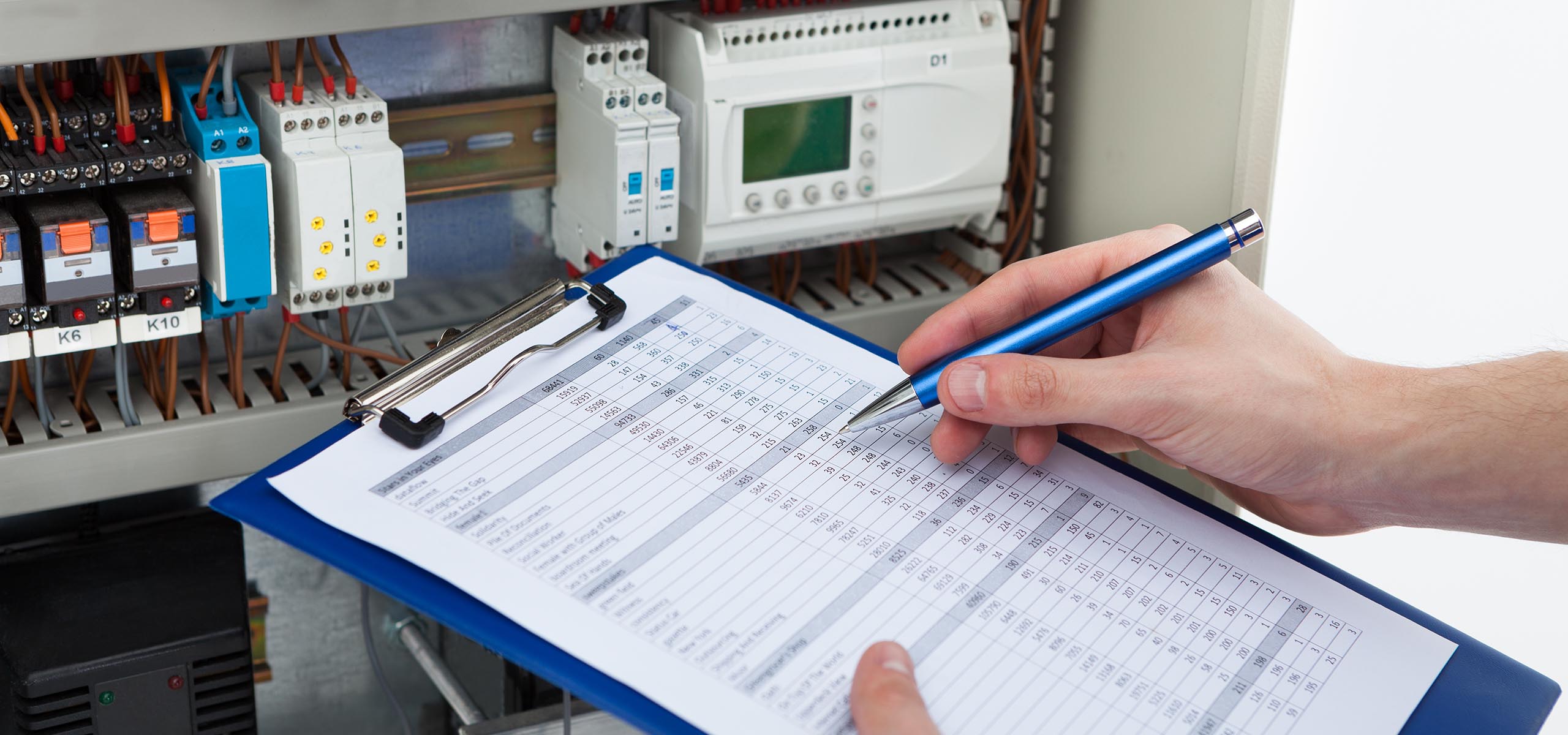 Electrician testing a circuit while producing EICR reports in Stafford
