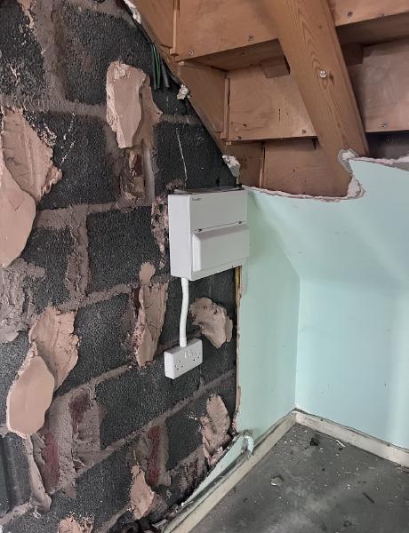 New consumer unit and socket on exposed brickwork during a house rewire
