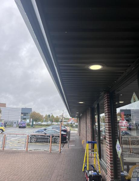 Recessed downlights fitted into a retail canopy soffit in Staffordshire