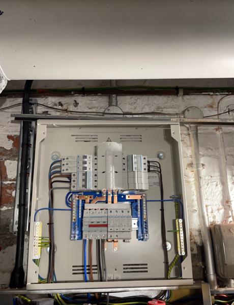 Three-phase distribution board with busbars and RCBOs in a commercial cellar