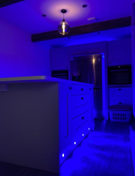 Blue RGB plinth and cabinet lighting in a kitchen, showing electrical work in Stafford