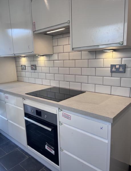 Under-cabinet lighting, sockets, oven and hob in a newly fitted kitchen